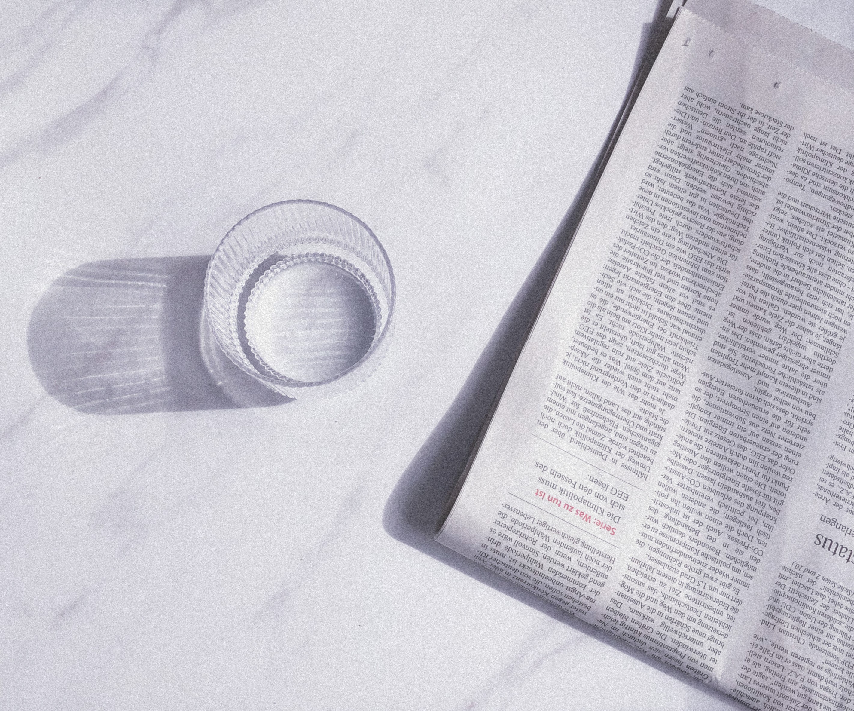 a photograph a newspaper and a glass of water